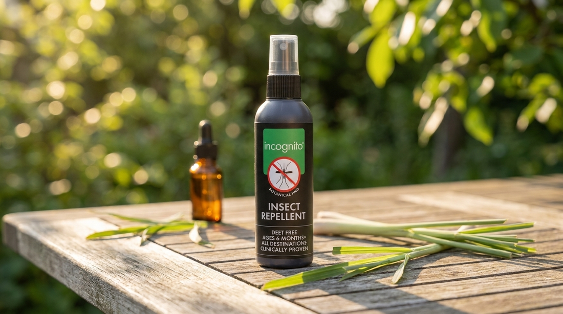 incognito® DEET-free insect repellent spray on a wooden garden table beside fresh lemongrass and an essential oil bottle