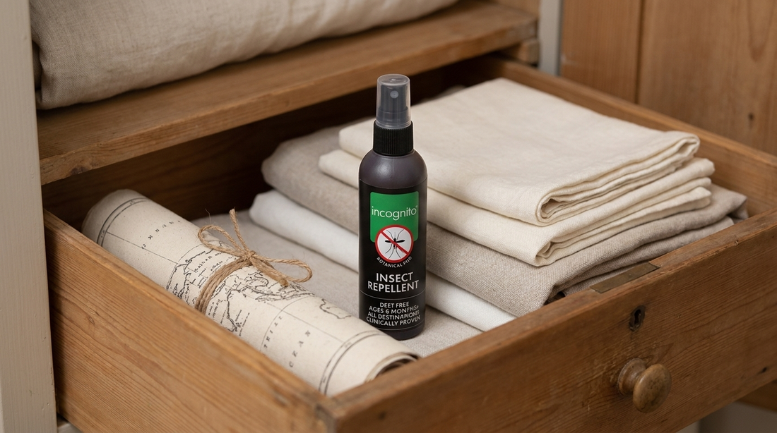 An incognito® DEET-free insect repellent spray bottle stored upright in a cool, dark wooden drawer beside folded linen — the right way to store insect repellent.
