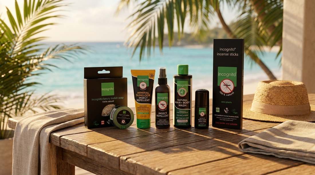incognito Elite Traveller Bundle travel kit with DEET-free insect repellent spray, roll-on and SPF30 sunblock on a wooden table by a tropical beach