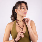 Woman wearing the incognito wooden insect repellent necklace, doubled as a choker and long strand